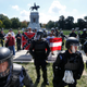 BY ANY MEANS NECESSARY: Virginians far and wide stand and protect the statue of Confederate General Robert E. Lee. This a Sept 2017 image on Monument Avenue in Richmond, Va.